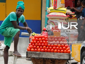 A tomato seller is awaiting buyers as many raw food vendors are recording low sales during the Ramadan period in Ogba, Lagos, Nigeria, on Ma...