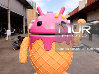 The Google Android logo and mascot, known as Bugdroid by the community, is being displayed as a statue resembling a strawberry ice-cream con...