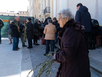 A woman bringing olive branches is seen in L’Aquila, Italy, on March 24th, 2024. Palm Sunday, observed on the Sunday before Easter, is celeb...