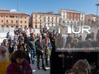 People attending a blessing of olive branches ceremony are seen in Piazza Duomo square in L’Aquila, Italy, on March 24th, 2024. Palm Sunday,...