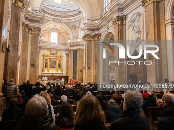 People attending a Holy Mass in Santa Maria del Suffragio church (also known as “Holy Souls Church”) are seen in L’Aquila, Italy, on March 2...