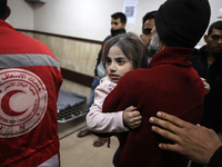 Palestinians are carrying injured victims to the hospital following an Israeli airstrike on a residential building in Al-Mughraqa, Central G...