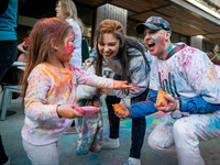 A family celebrates Holi, the Hindu holiday marking love and spring, in Washington, DC, March 25, 2024.   The holiday, often known as the Fe...