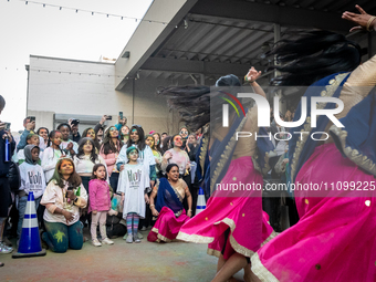 People watch Desi Moves and Vibes perform at a celebration of Holi, the Hindu holiday marking love and spring, in Washington, DC, March 25,...