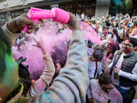 A man sprays the crowd with pink powder during a celebration of Holi, the Hindu holiday marking love and spring, in Washington, DC, March 25...
