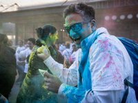 A man throws colored powder on a friend while celebrating Holi, the Hindu holiday marking love and spring, in Washington, DC, March 25, 2024...