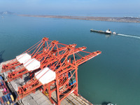 A cargo ship is stopping at a berth to load and unload containers at the container terminal in Lianyungang Port, in Lianyungang, China, on M...