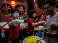 Indonesian Muslims are receiving food for iftar during the holy month of Ramadan at a temple in Jakarta, Indonesia, on March 26, 2024. As mi...