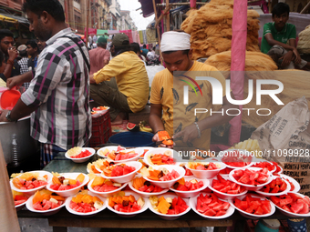 Muslim vendors in Kolkata, India, are selling fruits outside the Nakhoda Mosque during the holy fasting month of Ramadan on March 26, 2024....