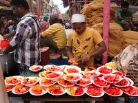 Muslim vendors in Kolkata, India, are selling fruits outside the Nakhoda Mosque during the holy fasting month of Ramadan on March 26, 2024....