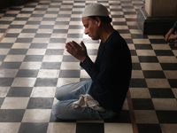 A Muslim man is offering prayers before breaking his fast on the first Iftar of the holy month of Ramadan in a mosque in Kolkata, India, on...