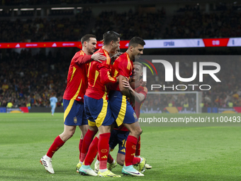 Several players from Spain are celebrating a goal during the friendly match between Spain and Brazil at Santiago Bernabeu Stadium in Madrid,...