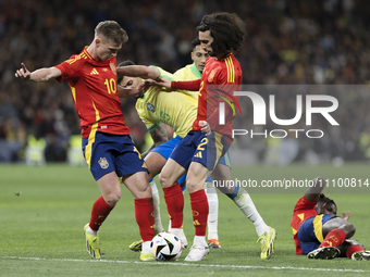 Dani Olmo of Spain, Bruno Guimaraes, and Marc Cucurella of Spain are fighting for the ball during the friendly match between Spain and Brazi...
