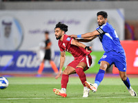 Yousef Al Sulaiman (R) of Kuwait is in action against Tarek Salman of Qatar during the FIFA World Cup 2026 and the AFC Asian Cup Saudi Arabi...