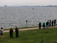 People view the collapsed Francis Scott Key Bridge in Baltimore, Maryland from the Fort McHenry National Monument and Historic Shrine on Mar...