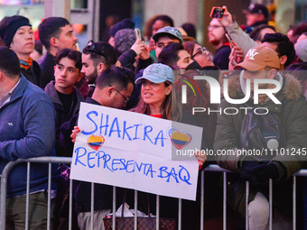 Fans are watching Colombian singer-songwriter Shakira, who is performing in New York, on March 26, 2024, at the southeast corner of Broadway...