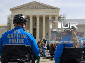 U.S. Capitol Police watch as abortion rights demonstrators face off with counterprotestors outside of the Supreme Court in Washington, D.C....