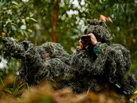SWAT officers are conducting a tactical drill in a mountain forest in Liuzhou, China, on March 26, 2024. (