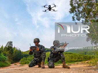 SWAT officers are using drones to conduct reconnaissance during a tactical drill in a mountain forest in Liuzhou, Guangxi Province, China, o...