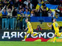 Mykhailo Mudryk and Oleksandr Zinchenko are celebrating after scoring a goal for Ukraine during the UEFA EURO 2024 Play-Offs final match bet...