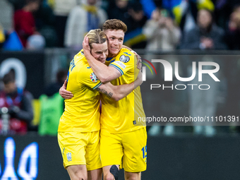 Mykhailo Mudryk and Viktor Tsygankov are celebrating after scoring a goal for Ukraine during the UEFA EURO 2024 Play-Offs final match betwee...