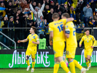 Viktor Tsygankov and Georgiy Sudakov are celebrating a goal for Ukraine during the UEFA EURO 2024 Play-Offs final match between Ukraine and...