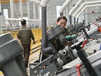 A worker is producing drill tail wire products for export overseas at a digital intelligent production workshop at a hardware manufacturing...