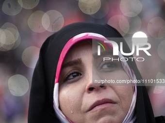 A veiled Iranian woman is crying while participating in a religious gathering to commemorate the holy month of Ramadan at the Azadi (Freedom...