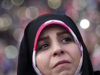 A veiled Iranian woman is crying while participating in a religious gathering to commemorate the holy month of Ramadan at the Azadi (Freedom...