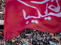 Iranian worshippers and supporters of Iran's Supreme Leader Ayatollah Ali Khamenei are waving Iranian and Palestinian flags while participat...