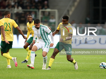 Houssem Eddine Aouar of Algeria is in action with Themba Zwane of South Africa during the international friendly match in Algiers, Algeria,...