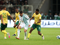 Houssem Eddine Aouar of Algeria is in action with Themba Zwane of South Africa during the international friendly match in Algiers, Algeria,...