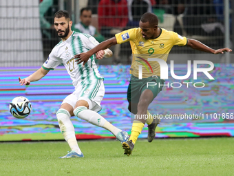 Mohamed Amine Madani (L) of Algeria is in action with Lqraam Rayners of South Africa during the international friendly match in Algiers, Alg...
