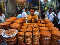 People are barbecuing various meats known as ''Kabab'' for sale ahead of Iftar at a marketplace during the month of Ramadan in Kolkata, Indi...