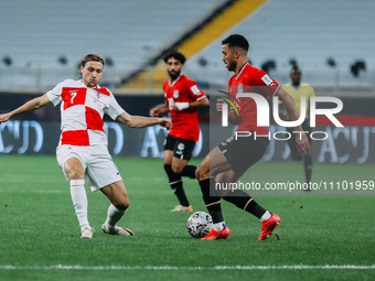 Mohamed Abdel Moneim is playing with a Croatian national team player during a friendly football match between Egypt and Croatia at Misr Stad...