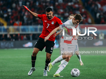 Mahmoud Trezeguet is playing with a Croatian national team player during a friendly football match between Egypt and Croatia at Misr Stadium...