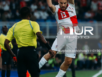 A Croatian national team player is participating in a friendly football match between Egypt and Croatia at Misr Stadium in the New Administr...
