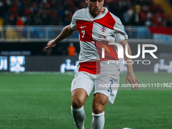 A Croatian national team player is participating in a friendly football match between Egypt and Croatia at Misr Stadium in the New Administr...