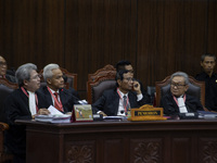 Presidential candidate Ganjar Pranowo (2nd L) and Vice Presidential candidate Mahfud MD (2nd R) are attending the first hearing of a petitio...