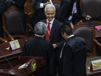 Presidential candidate Ganjar Pranowo (C) is reacting after the first hearing of a petition lawsuit concerning the February 14 presidential...
