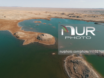 A view of the arid Yadan landscape with a moist lake nestled in the depths of the Gobi desert in Hami, Xinjiang province, China, on March 24...