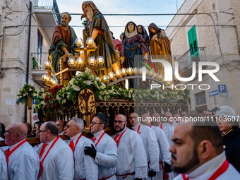 Statue bearers are carrying the figures during the procession of the Eight Saints in Ruvo di Puglia, Italy, on Holy Thursday, March 28, 2024...