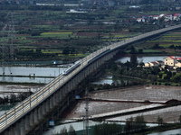 A Smart Fuxing bullet train is running on the Xinjiang West Branch Extra Large Bridge in Shangrao, Jiangxi Province, China, on March 28, 202...