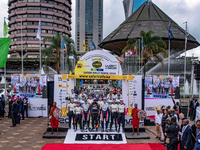 A family is posing for a photo during the ceremonial start of the FIA World Rally Championship WRC Safari Rally Kenya 2024 in Naivasha, Keny...