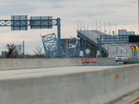 The collapsed Francis Scott Key Bridge is seen from a media staging area at the Maryland Tansportation Authority headquarters in Dundalk, Ma...