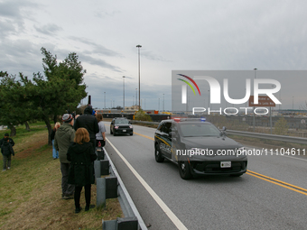 People view the collapsed Francis Scott Key Bridge from the side of Broening Highway in Dundalk, Maryland on March 28, 2024. (