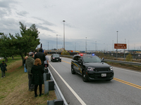 People view the collapsed Francis Scott Key Bridge from the side of Broening Highway in Dundalk, Maryland on March 28, 2024. (