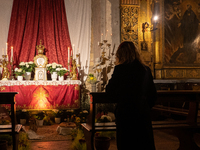 A woman visiting Sepulchers in the night is seen in Gubbio, Italy, on March 28th, 2024. Holy Thursday, preceding Good Friday, commemorates J...