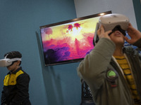 Two young Iranian boys are wearing Virtual Reality headsets to watch simulations of Imam Hussein and the battle of Karbala at Meta-Mosque, l...