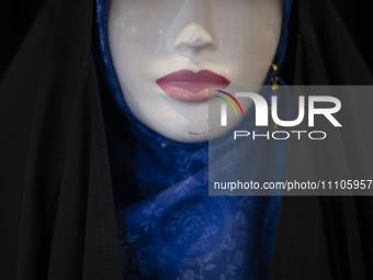 A mannequin is being covered with a mandatory hijab during the Hijab and Chastity fair at the Imam Khomeini Grand Mosque in downtown Tehran,...